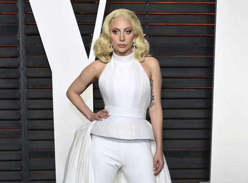 In this Feb. 28, 2016 file photo, Lady Gaga arrives at the Vanity Fair Oscar Party in Beverly Hills, Calif. Lady Gaga is choosing the intimacy of dive bars over arenas to showcase songs from her new album, "Joanne." AP