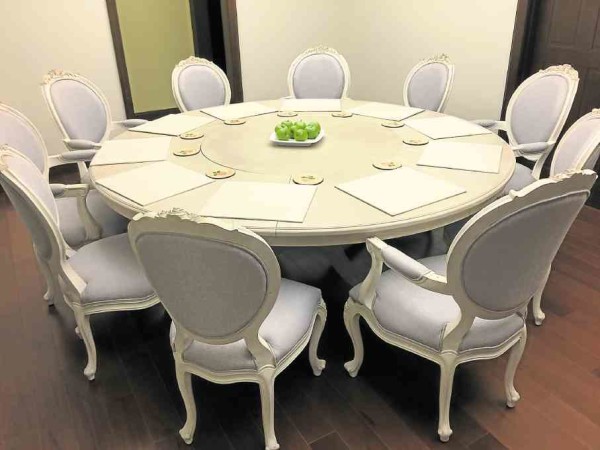 The 10-seater dining table hews to the lilac motif.