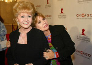 In this Tuesday, Aug. 19, 2003 file photo, Debbie Reynolds and Carrie Fisher arrive at the "Runway for Life" Celebrity Fashion Show Benefitting St. Jude's Children's Research Hospital and celebrating the DVD relese of Chicago in Beverly Hills, Calif. On Tuesday, Dec. 27, 2016, a publicist said Fisher has died at the age of 60. AP FILE PHOTO