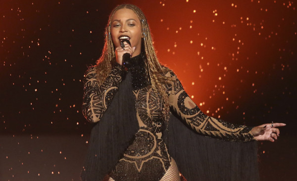FILE - In this June 26, 2016, file photo, Beyonce performs "Freedom" at the BET Awards in Los Angeles. There are few things Beyonce has not conquered, and the Grammy for album of the year is one of them. Beyonce's main competition is Adele, who won album, song and record of the year in 2010 with "21" and "Rolling In the Deep." The 2017 Grammy Awards are held Sunday, Feb. 12, 2017. (Photo by Matt Sayles/Invision/AP, File)