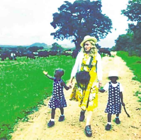 Madonna (center) and her adopted twin daughters