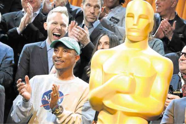 Pharrell Williams (front, left), best picture nominee (as producer of “Hidden Figures”), and Justin Paul (second row, left), best song nominee for two “La La Land” compositions