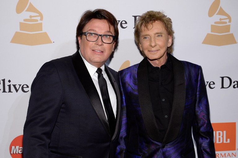 (FILES) This file photo taken on February 13, 2016 shows Garry Kief (L) and singer Barry Manilow attending the 2016 Pre-GRAMMY Gala and Salute to Industry Icons honoring Irving Azoff at The Beverly Hilton Hotel in Beverly Hills, California.    Chart-topping singer Barry Manilow came out of the closet Wednesday, April5, 2017 at age 73, saying he kept silent on his nearly four-decade relationship with a man to avoid disappointing fans. Manilow, best known for his love ballad "Mandy" and Latin-tinged pop number "Copacabana (at the Copa)"), confirmed his sexuality two years after gossip media discovered his marriage to his manager Garry Kief.  / AFP PHOTO / GETTY IMAGES NORTH AMERICA / KEVORK DJANSEZIAN