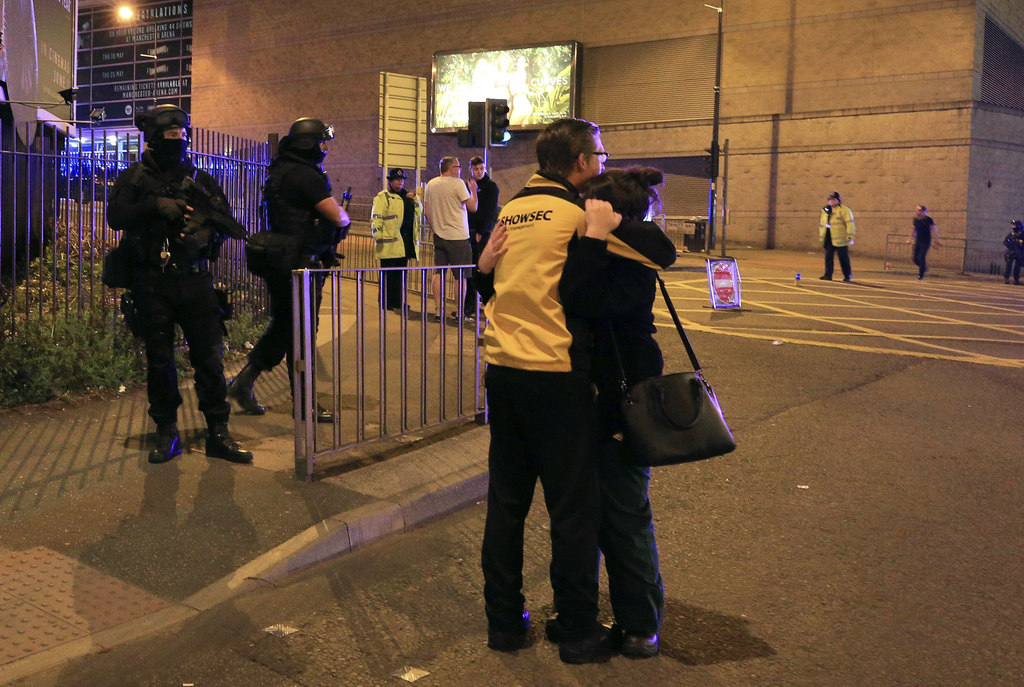 Armed police stand guard at Manchester Arena after reports of an explosion at the venue during an Ariana Grande gig  in Manchester, England Monday, May 22, 2017. Police says there are "a number of fatalities" after reports of an explosion at an Ariana Grande concert in northern England. (Peter Byrne/PA via AP)