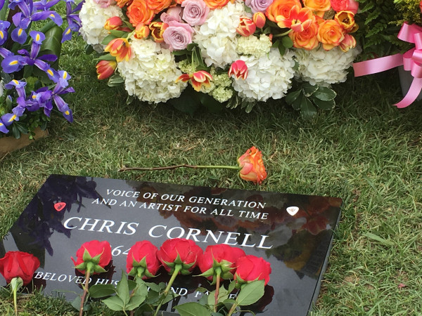 Flowers adorn the grave marker for musician Chris Cornell at the Hollywood Forever Cemetery on Friday, May 26, 2017, in Los Angeles.  Cornell, 52, who gained fame as the lead singer of the bands Soundgarden and Audioslave, died at a hotel in Detroit last week. (AP Photo/Sandy Cohen)