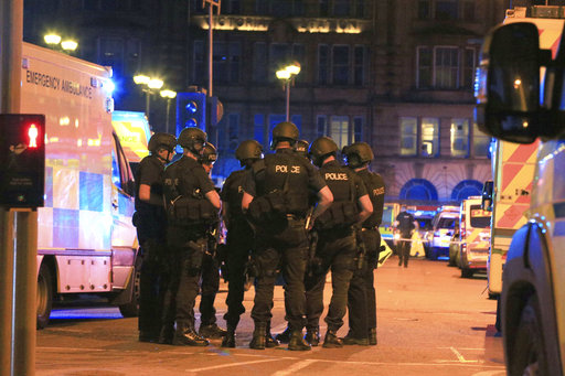 Armed police gather at Manchester Arena after reports of an explosion at the venue during an Ariana Grande gig  in Manchester, England Monday, May 22, 2017. Several people have died following reports of an explosion Monday night at an Ariana Grande concert in northern England, police said. A representative said the singer was not injured. (Peter Byrne/PA via AP)