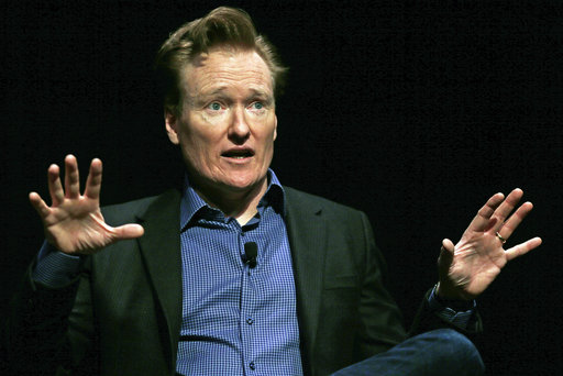 In this Feb. 12, 2016 file photo television host Conan O'Brien gestures to the audience at Sanders Theatre on the campus of Harvard University in Cambridge. O'Brien is vigorously defending himself from plagiarism allegations by a writer who accused him of ripping off punchlines about Caitlyn Jenner, Tom Brady and the Washington Monument. AP FILE PHOTO
