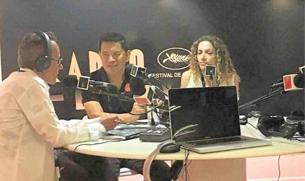 Brillante Ma Mendoza (center)  grants interview with Cannes Radio.