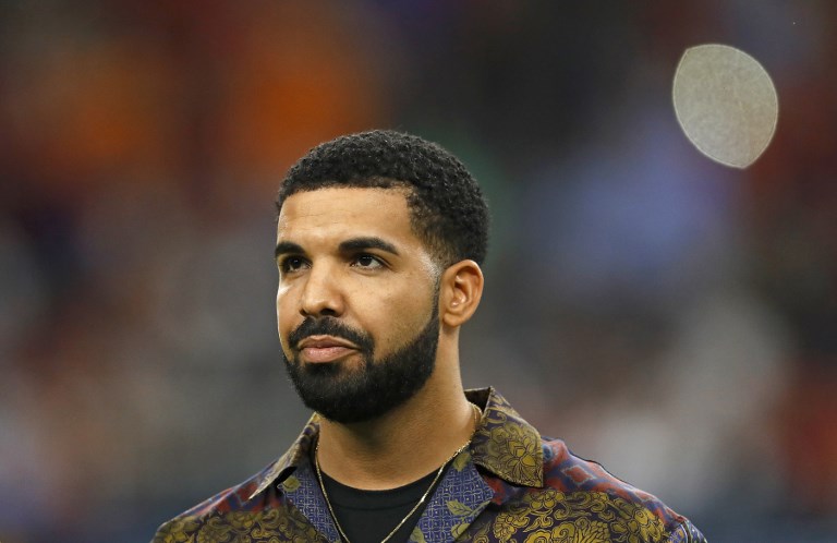 (FILES) In this file photo taken on July 20, 2017 Rapper Drake looks on prior to the International Champions Cup soccer match between Manchester City against Manchester United at NRG Stadium in Houston, Texas. Drake has smashed streaming records on June 30, 2018, with his new album "Scorpion," with Apple Music and Spotify both reporting unprecedented listenership in its first day. Apple Music said on Instagram that the Canadian hip-hop superstar's fifth studio album was streamed 170 million times in the 24 hours since its release Friday. / AFP PHOTO / AARON M. SPRECHER