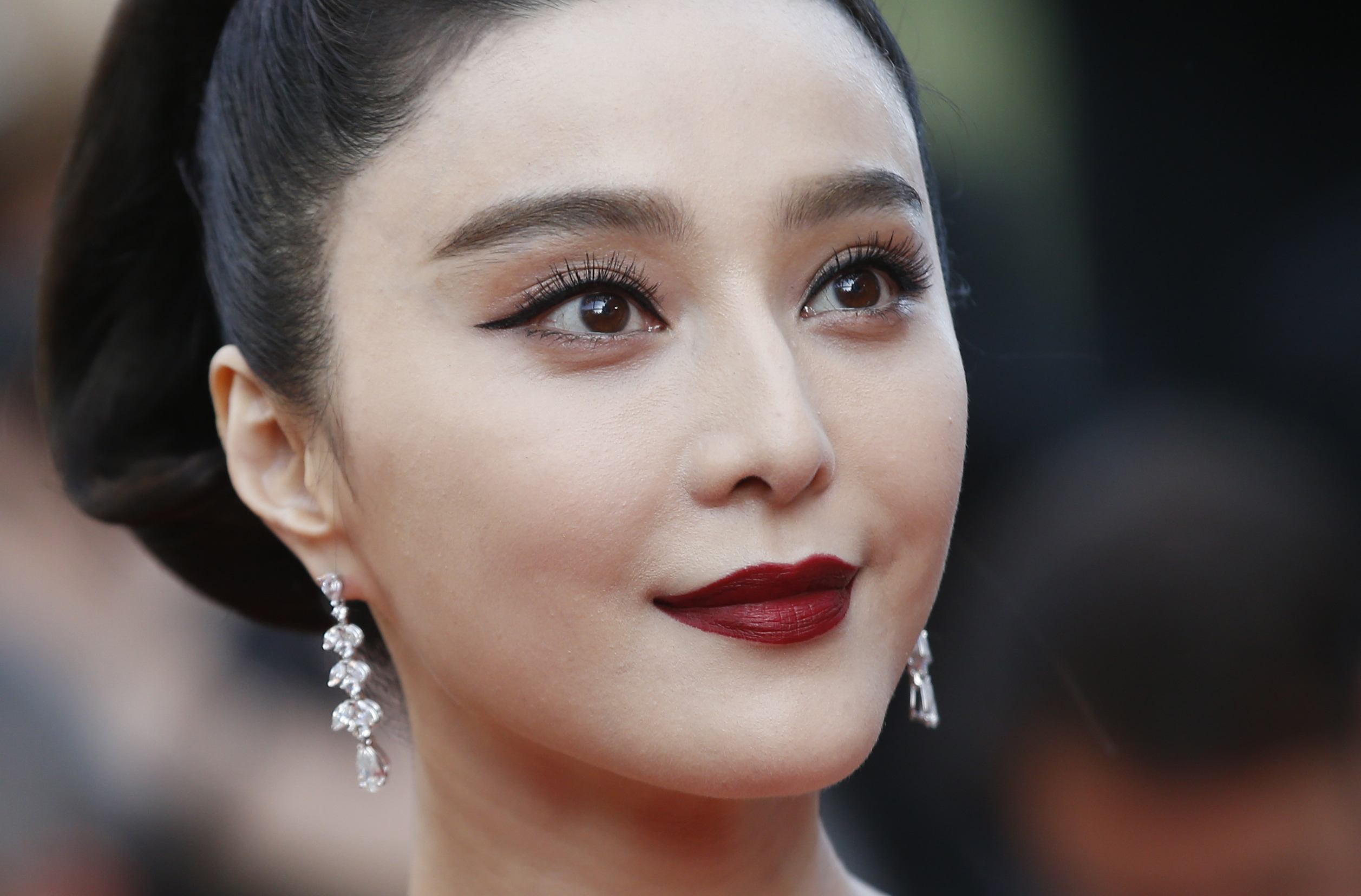 FILE - In this May 24, 2017, file photo, Fan Bingbing poses for photographers as she arrives for the screening of the film The Beguiled at the 70th international film festival, Cannes, southern France. Fan Bingbing, one of China's best-known starlets and a rising Hollywood star, has well and truly fallen off the map amid vague allegations of tax shenanigans and possibly other infractions that have put her at odds with China's Communist Party-appointed culture czars. (AP Photo/Alastair Grant, File)