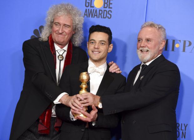 Brian May, left, and Roger Taylor, right, of Queen, and Rami Malek pose in the press room with the award for best motion picture, drama for "Bohemian Rhapsody" at the 76th annual Golden Globe Awards at the Beverly Hilton Hotel on Sunday, Jan. 6, 2019, in Beverly Hills, Calif. (Photo by Jordan Strauss/Invision/AP)