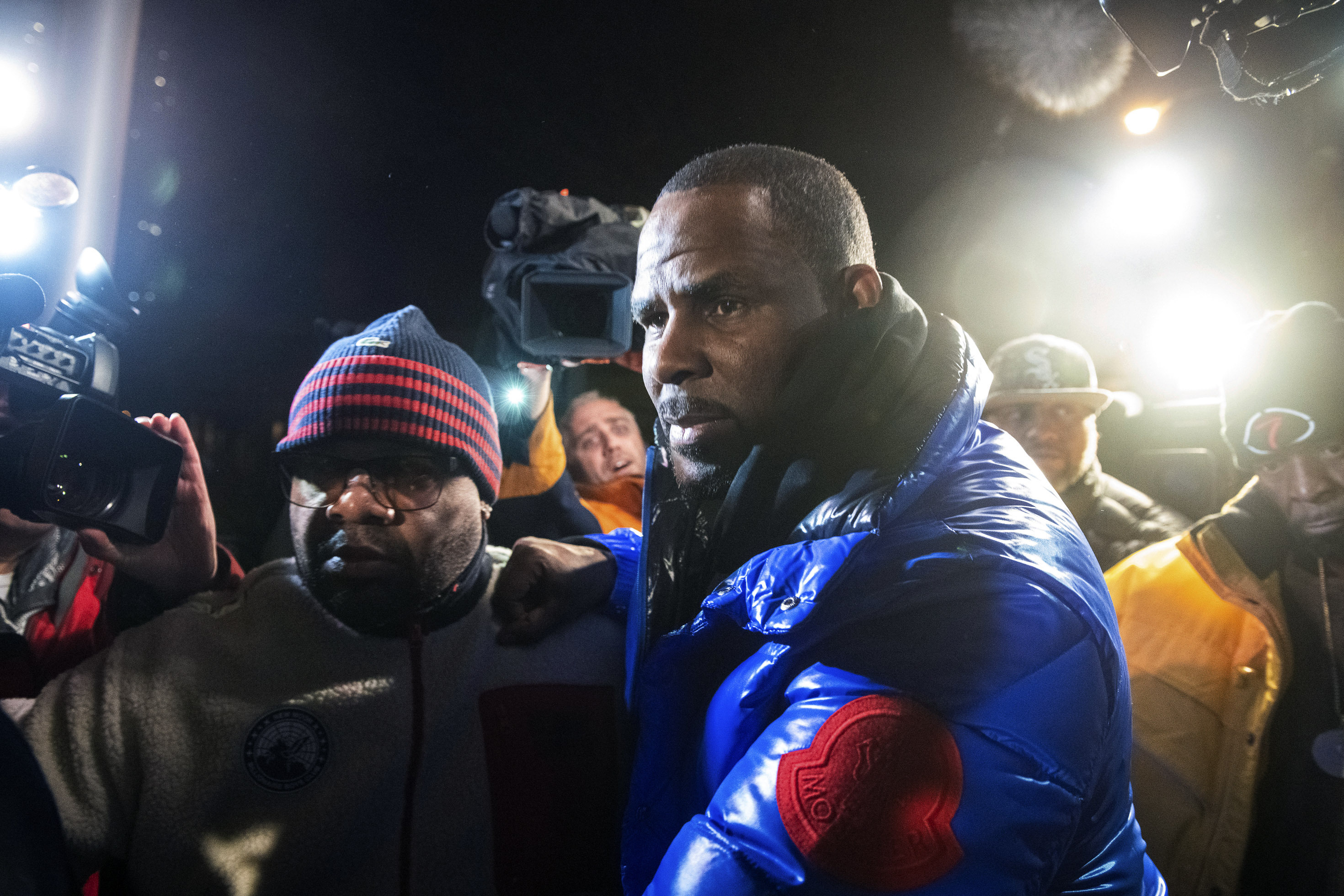 R. Kelly surrenders to authorities at Chicago First District police station, Friday, Feb. 22, 2019.  R&B star R. Kelly was taken into custody after arriving Friday night at a Chicago police precinct, hours after authorities announced multiple charges of aggravated sexual abuse involving four victims, including at least three between the ages of 13 and 17. (Tyler LaRiviere/Chicago Sun-Times via AP)