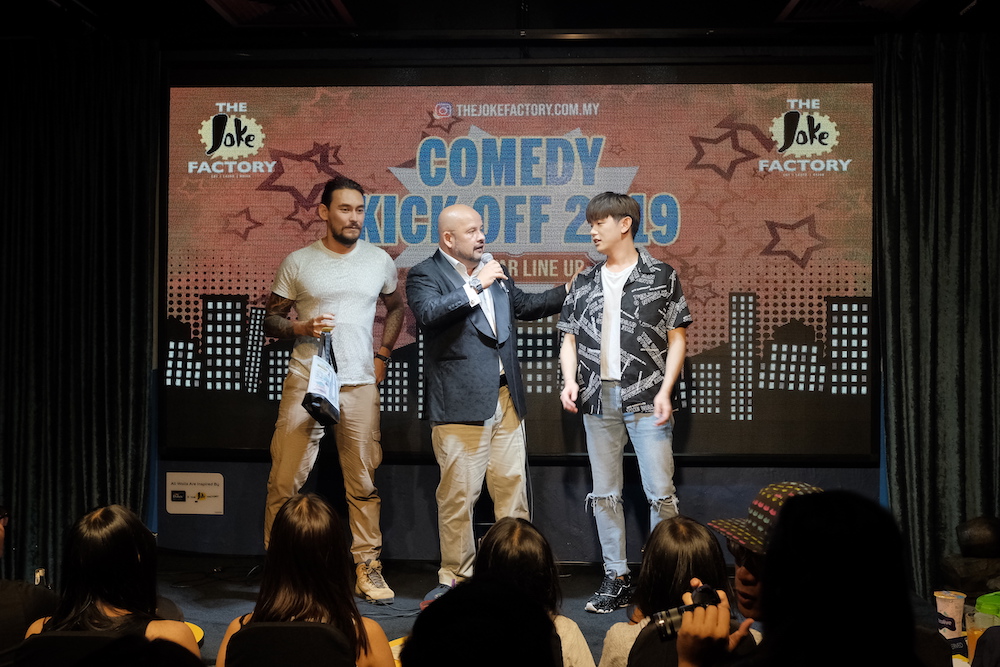 Eric Nam doing a stand-up comedy act for a challenge