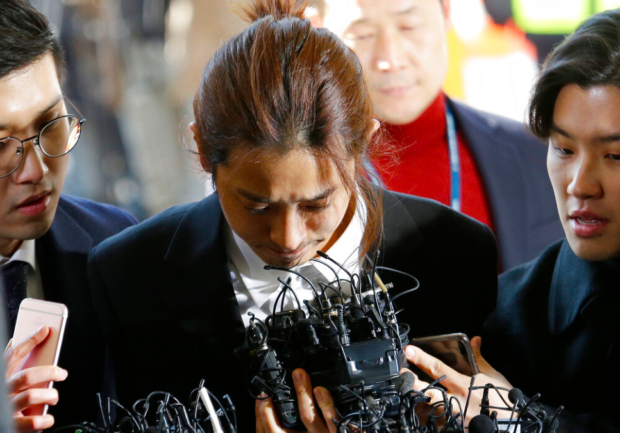 K-pop singer Jung Joon-young (center) arrives at the Seoul Metropolitan Police Agency in Seoul, South Korea on March 14, 2019. AP