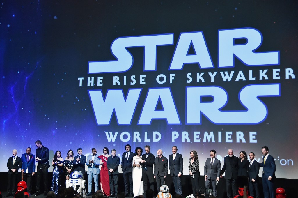 HOLLYWOOD, CALIFORNIA - DECEMBER 16: (L-R) Anthony Daniels, Billy Dee Williams, Joonas Suotamo, Kelly Marie Tran, Keri Russell, Oscar Isaac, John Boyega, Daisy Ridley, Mark Hamill, Adam Driver, Naomi Ackie, Richard E. Grant, Ian McDiarmid, The Walt Disney Company Chairman and CEO Bob Iger, Producer and President of Lucasfilm Kathleen Kennedy, Director, Writer and Producer J.J. Abrams, composer John Williams, producer Michelle Rejwan, Writer Chris Terrio and executive producer Callum Greene speak onstage during the World Premiere of "Star Wars: The Rise of Skywalker", the highly anticipated conclusion of the Skywalker saga on December 16, 2019 in Hollywood, California.   Alberto E. Rodriguez/Getty Images for Disney/AFP