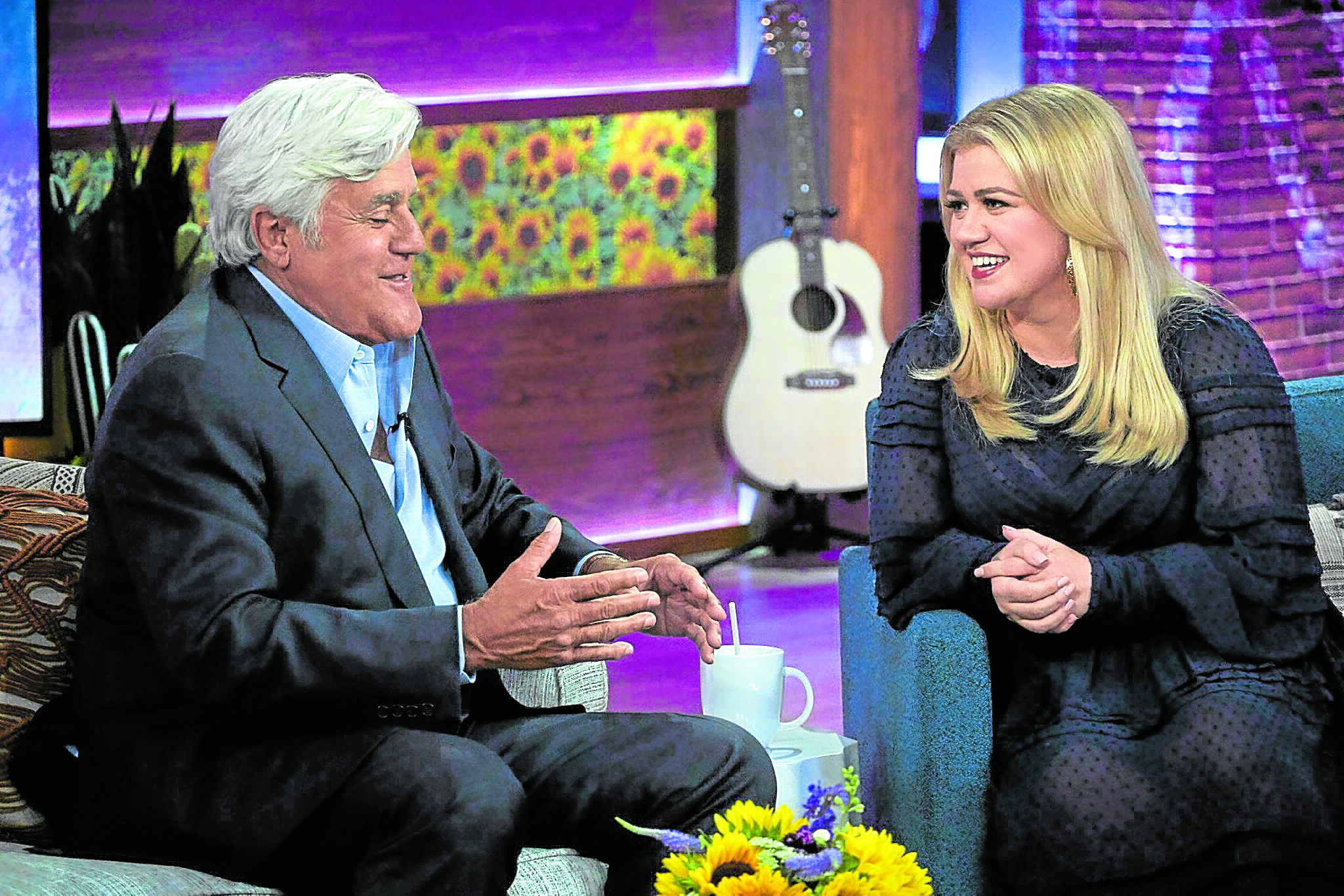 The singer-host (right) with Jay Leno