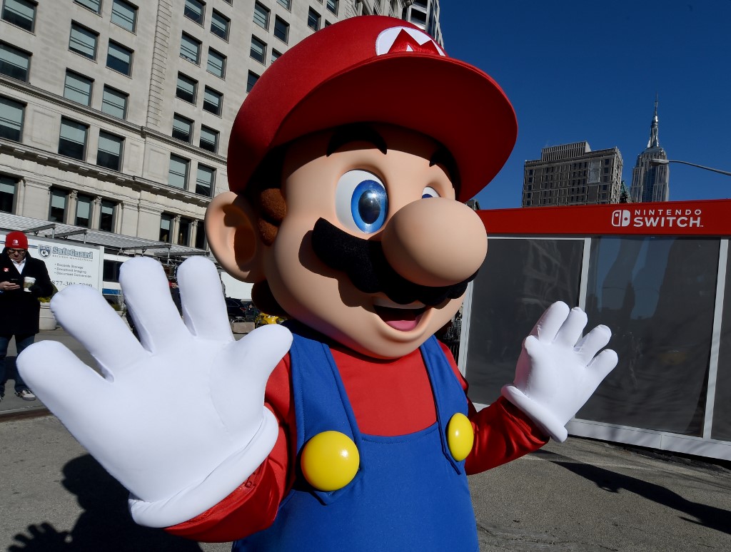 Mario from Super Mario Bros. poses for pictures as the Nintendo Switch is unveiled at  a pop-up Living room in Madison Square Park in New York on March 3, 2017. - Nintendo Switch is a first-of-its-kind video game system where you can play at home and take it on-the-go. (Photo by TIMOTHY A. CLARY / AFP)