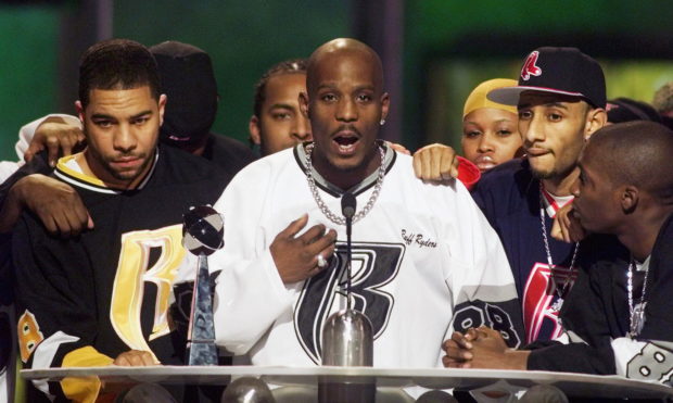 Rapper DMX (C) offers a prayer after winning the R&B Albums Artist of the Year award at the Billboard Music Awards show at the MGM Grand Hotel in Las Vegas December 8, 1999