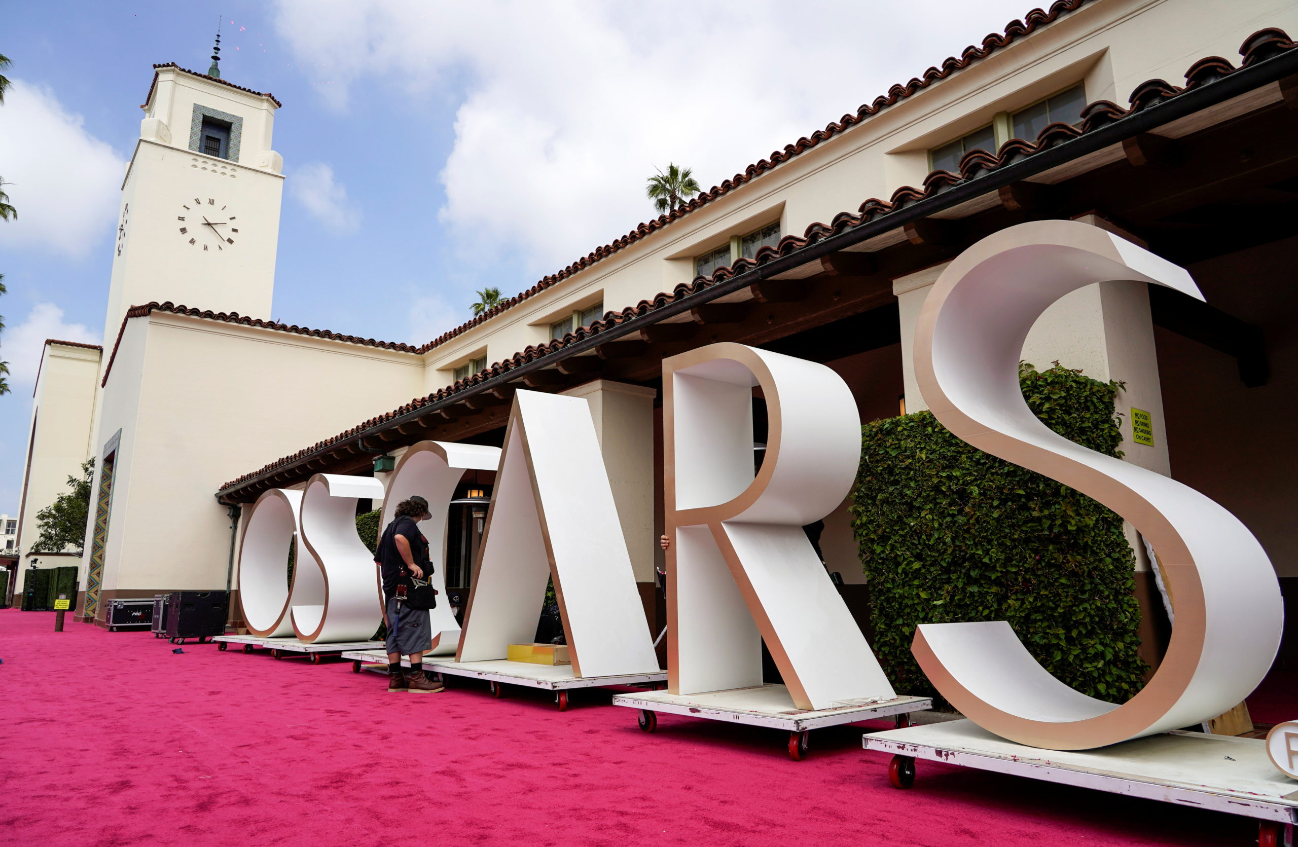 A crew member looks over a background element for the red carpet at Union Station, one of the locations for the 93rd Academy Awards in Los Angeles, California, U.S.  April 24, 2021. Chris Pizzello/Pool via REUTERS