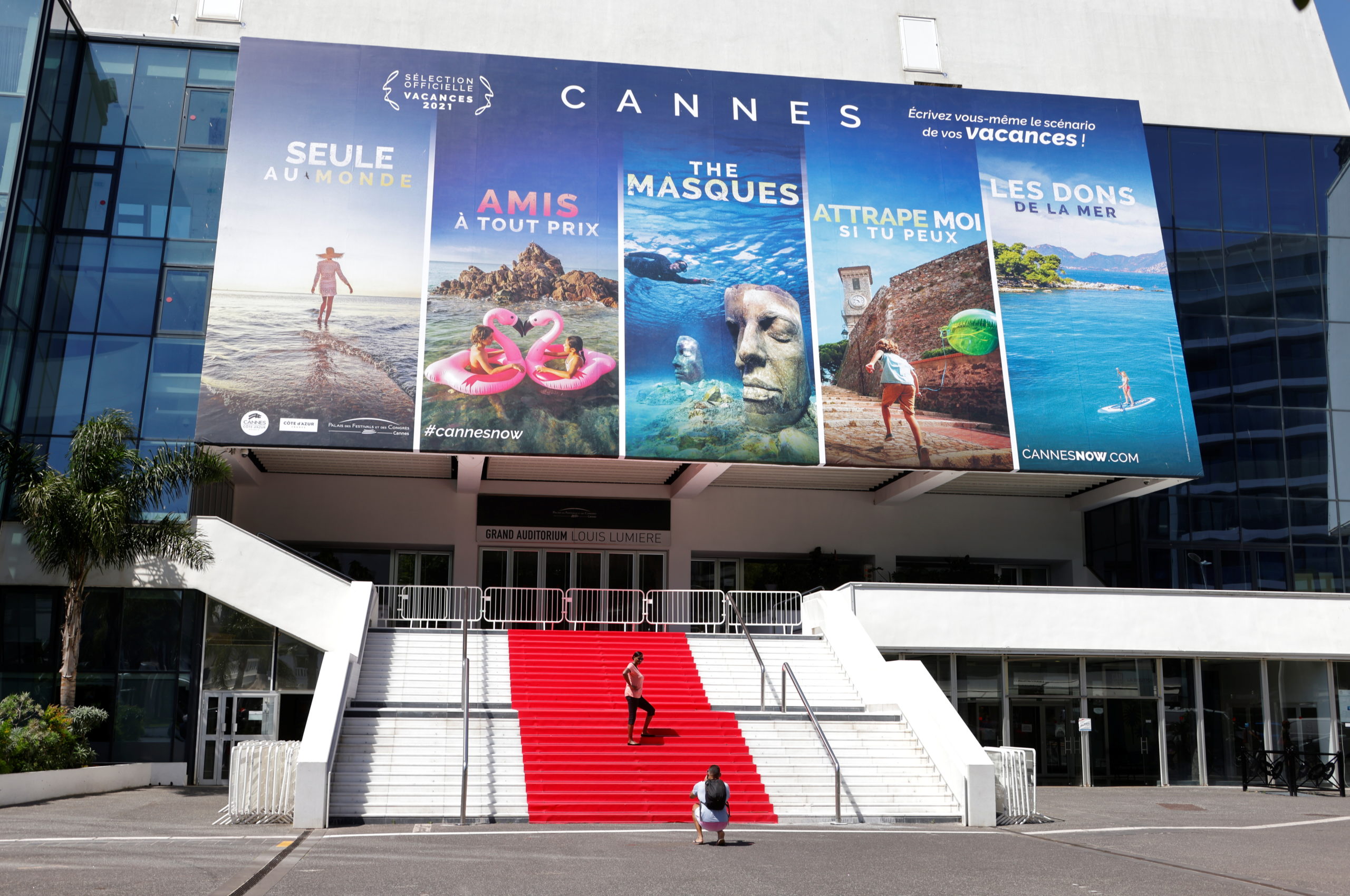 People stand on the red carpet of the Festival palace in Cannes as the French Riviera prepares for the 2021 edition of the Cannes Film Festival which will take place next July, in France, June 3, 2021.  REUTERS/Eric Gaillard