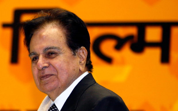 Bollywood star Dilip Kumar smiles after receiving an award in New Delhi