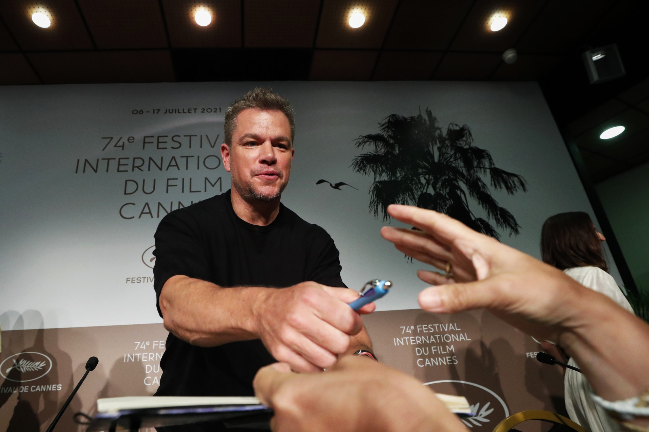 The 74th Cannes Film Festival - News conference for the film  "Stillwater" Out of Competition - Cannes, France, July 9, 2021.  Cast member Matt Damon signs autographs. REUTERS/Eric Gaillard