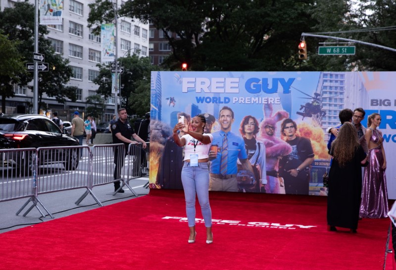 A guest takes a selfie on the red carpet at the premiere for the film "Free Guy" in New York City, New York, U.S., August 3, 2021. REUTERS/Caitlin Ochs