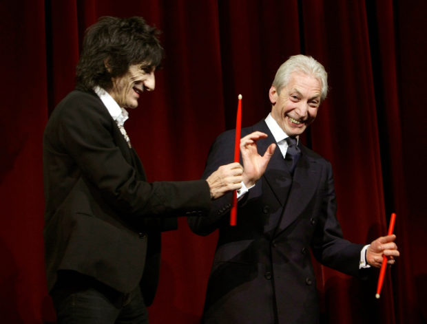 Rolling Stones Ron Wood and Charlie Watts (R) joke on the stage before the screening of their film 'Shine A Light' at the opening ceremony of the 58th Berlinale International Film Festival in Berlin February 7, 2008