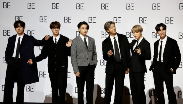 Members of K-pop boy band BTS pose for photographs during a news conference promoting their new album "BE(Deluxe Edition)" in Seoul