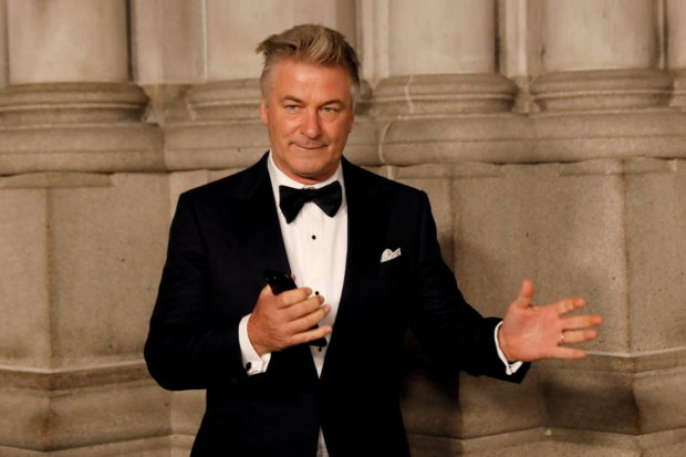 Actor Alec Baldwin gestures before walking on the red carpet during the commemoration of the Elton John AIDS Foundation 25th year fall gala at the Cathedral of St. John the Divine in New York City