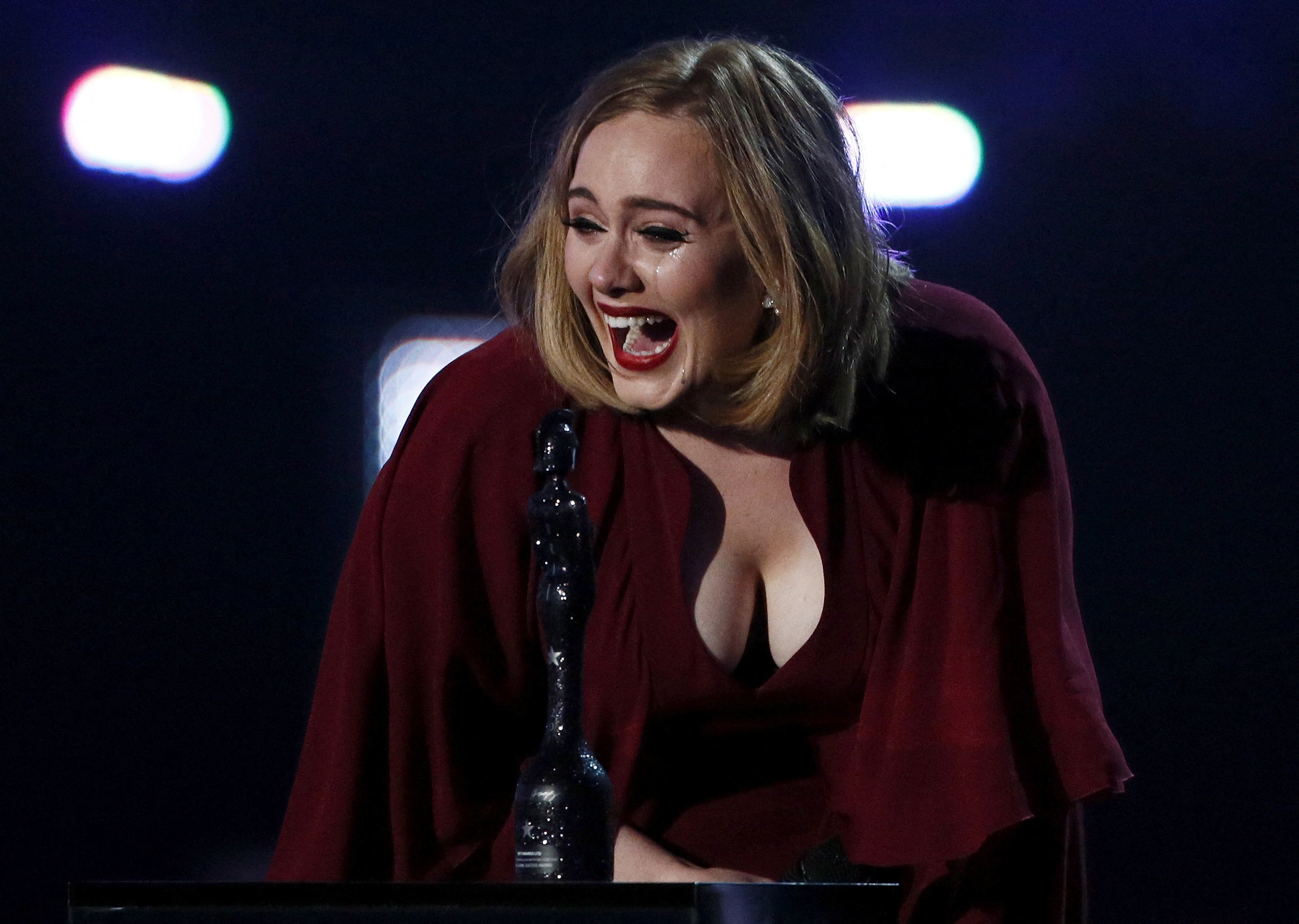 Adele reacts as she accepts the global success award at the BRIT Awards at the O2 arena in London, February 24, 2016. REUTERS/Stefan Wermuth