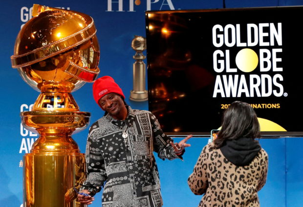 Rapper Snoop Dogg poses next to the Golden Globe statue at the 79th Annual Golden Globe Awards nominations announcement in Beverly Hills, California, U.S., December 13, 2021. REUTERS/Mario Anzuoni