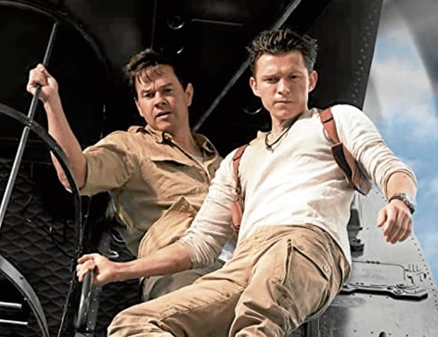 Mark Wahlberg (left) and Tom Holland in “Uncharted.