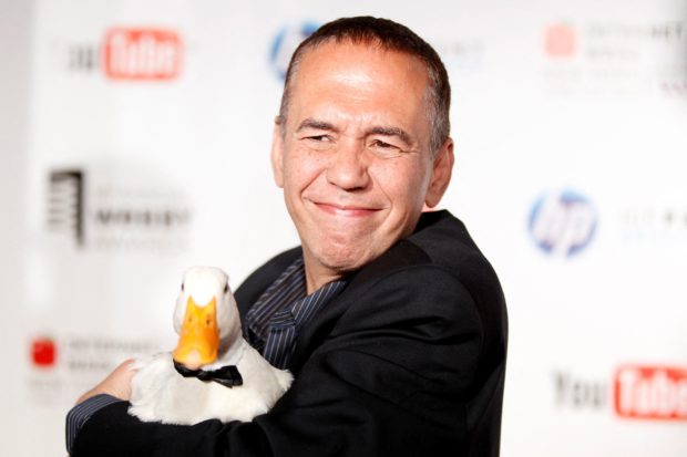 FILE PHOTO: Comedian Gilbert Gottfried arrives with a duck at the Webby Awards in New York June 14, 2010. REUTERS/Lucas Jackson