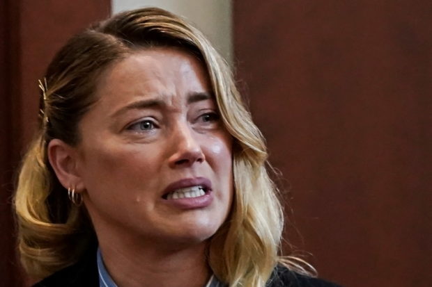 Actor Amber Heard testifies at Fairfax County Circuit Court during a defamation case against her by ex-husband, actor Johnny Depp in Fairfax, Virginia, U.S., May 4, 2022. Heard said there was an incident where Depp performed a cavity search while accusing her of harboring his drugs. REUTERS/Elizabeth Frantz/Pool
