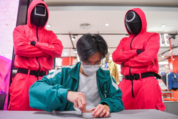 A man participates in a Netflix series 'Squid Game' mission at a department store in Bangkok
