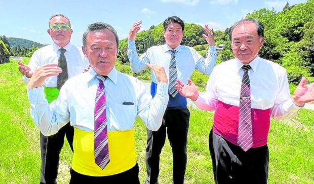 members of the group dancing while wearing neckties and coloured belly warmers in Wake town, western Okayama prefecture. STORY: Dancing ‘old heartthrobs’ become Japan’s TikTok sensation