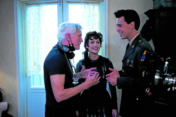 Director Baz Luhrmann (left) on the set with Olivia DeJonge (as Priscilla Presley) and Butler