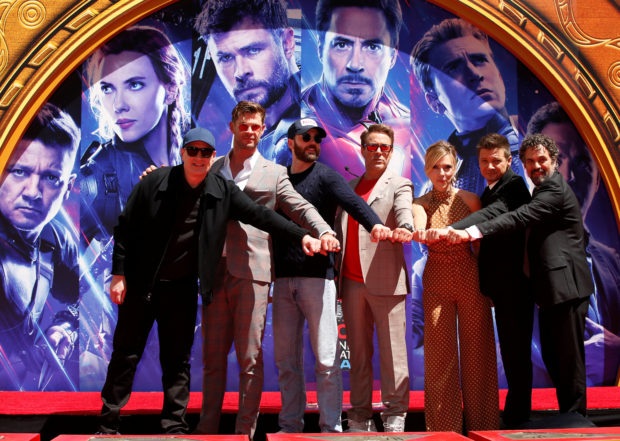 Robert Downey Jr., Chris Evans, Mark Ruffalo, Chris Hemsworth, Scarlett Johansson, Jeremy Renner and Marvel Studios President Kevin Feige place their handprints in cement at a ceremony at the TCL Chinese Theatre in Hollywood