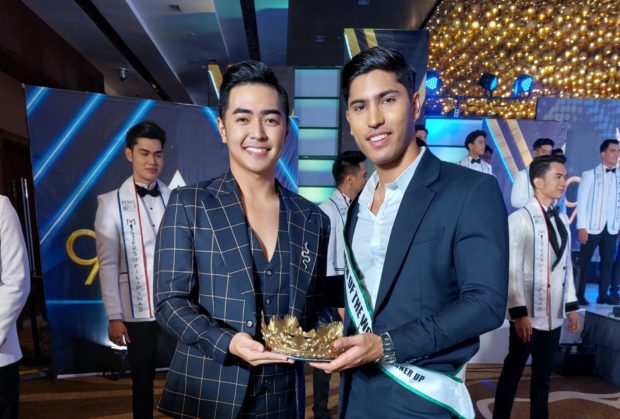 Reigning Misters of Filipinas kings Nadim Elzein (right) and Junichi Yabushita show one of the crowns at stake in this year’s pageant./ARMIN P. ADINA