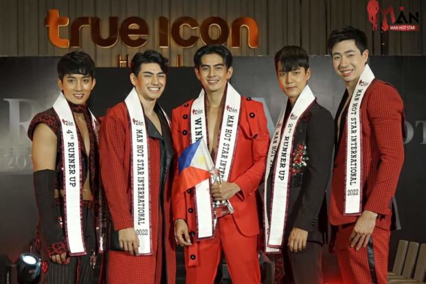 Man Hot Star International winner Jovy Bequillo of the Philippines (center) is flanked by his runners-up after the competition./MAN HOT STAR THAILAND FACEBOOK PHOTO