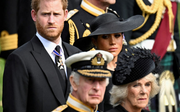 FILE PHOTO: Britain's Meghan, Duchess of Sussex, cries as she, Prince Harry, Duke of Sussex, Queen Camilla and King Charles attend the state funeral and burial of Britain's Queen Elizabeth, in London, Britain, September 19, 2022. REUTERS/Toby Melville