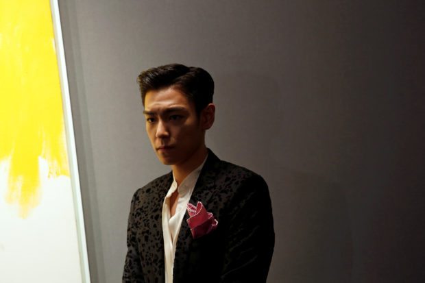 Choi Seung-hyun, known by stage name T.O.P, poses at Sotheby's preview in Hong Kong