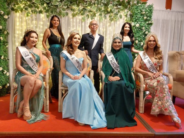 Patricia Javier (standing, left) is joined by NQULI founder Eren Noche (standing, right) and pageant mentor Rodgil Flores, with four of this year’s delegates (seated, from left) Sheralene Shirata, Cristina Gonzales-Romualdez, Leira Buan, and Marjorie Renner. Image: ARMIN P. ADINA