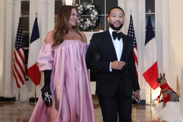Chrissy Teigen and John Legend arrive for a state dinner in honor of French President Emmanuel Macron at the White House in Washington, U.S., December 1, 2022. REUTERS/Amanda Andrade-Rhoades