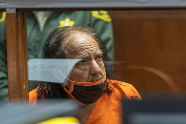 FILE PHOTO: Adult film star Ron Jeremy, whose real name is Ronald Jeremy Hyatt and who is charged with raping three women and sexually assaulting a fourth in incidents in West Hollywood from 2014 to 2019, listens as his attorney Stuart Goldfarb (not pictured) speaks during an arraignment hearing at Clara Shortridge Foltz Criminal Justice Center in Los Angeles, California, U.S., June 26, 2020. David McNew/Pool via REUTERS