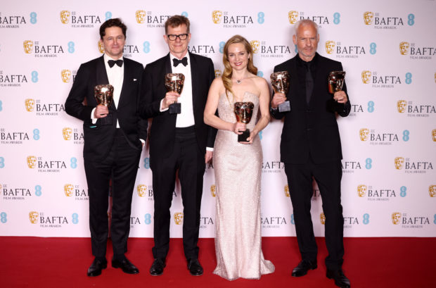 Graham Broadbent, Pete Czernin, and Martin Mcdonagh pose with their awards for Outstanding British Film for "The Banshees Of Inisherin" alongside Kerry Condon posing with her Best Supporting Actress award during the 2023 British Academy of Film and Television Arts (BAFTA) Film Awards at the Royal Festival Hall in London, Britain, February 19, 2023. REUTERS/Henry Nicholls