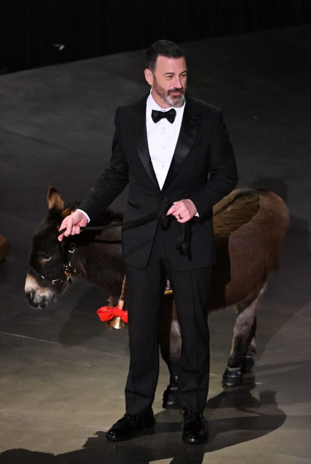 TV host Jimmy Kimmel walks onstage with a donkey during the 95th Annual Academy Awards at the Dolby Theatre in Hollywood, California on March 12, 2023. (Photo by Patrick T. Fallon / AFP)