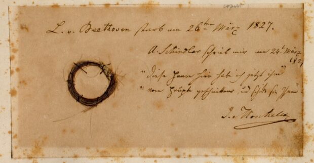 This undated image released by the Beethoven Studies, San Jose State University, shows the Moscheles Lock of German composer Ludwig van Beethoven, authenticated by the study, with inscription by former owner Ignaz Moscheles. - Beethoven died in Vienna nearly 200 years ago after a lifetime of composing some of the most influential works in classical music. Ever since, biographers have sought to explain the causes of the German composer's death at the age of 56, his progressive hearing loss and his well-documented struggles with chronic illness. A team of researchers who sequenced Beethoven's genome using locks of the German composer's hair may now have some answers. Liver failure, or cirrhosis, was the possible cause of Beethoven's death brought about by a number of factors, including the composer's alcohol consumption, they said. (Photo by Ira F. Brilliant / Center for Beethoven Studies, San Jose State University / AFP) / RESTRICTED TO EDITORIAL USE - MANDATORY CREDIT "AFP PHOTO / Ira F. Brilliant / Center for Beethoven Studies, San Jose State University" - NO MARKETING NO ADVERTISING CAMPAIGNS - DISTRIBUTED AS A SERVICE TO CLIENTS