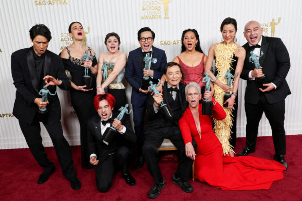 FILE PHOTO: Members of the cast of "Everything Everywhere All at Once" Harry Shum Jr., Jenny Slate, Andy Le, Tallie Medel, Ke Huy Quan, James Hong, Stephanie Hsu, Jamie Lee Curtis, Michelle Yeoh and Brian Le, pose with the award for Outstanding Performance by a Cast in a Motion Picture during the 29th Screen Actors Guild Awards at the Fairmont Century Plaza Hotel in Los Angeles, California, U.S., February 26, 2023. REUTERS/Aude Guerrucci/